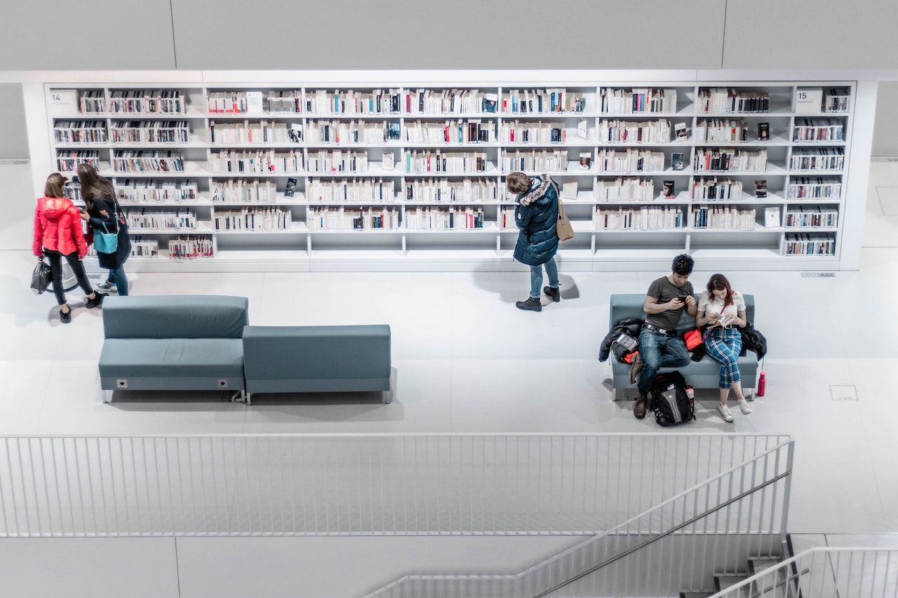 White library interior with people browsing