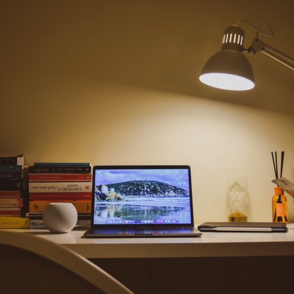 Laptop on desk under lamp